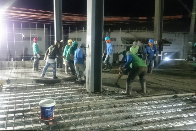 Pouring of concrete on metal deck.